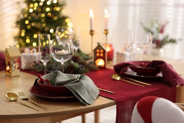 Christmas table setting with stylish dishware and festive decor indoors
