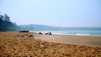 A Serene Beach Landscape featuring Gentle Waves lapping against the shore and Distant Hills beyond. Stock Clip