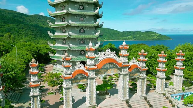 Thap Xa Loi temple showcases exquisite architecture surrounded by lush greenery and mountains near Da Nang, symbolizing Buddhist serenity and devotion.