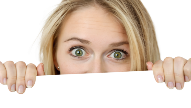 A blonde woman with vibrant green eyes peeks over a white surface, her expression showing curiosity and surprise, transparent background, png - Powered by Adobe