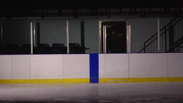 Hockey game bodycheck into the boards