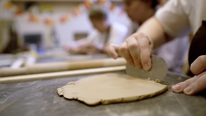 Creative Hands Engaged in Artistic Work The Art of Clay Shaping in Art Class Environment. Stock Clip