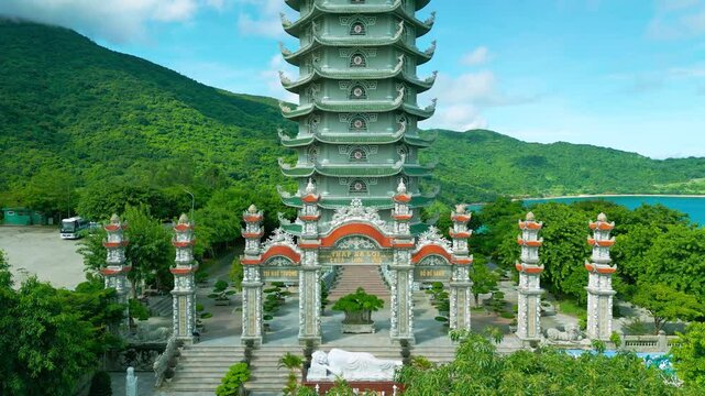 Thap Xa Loi is a stunning Buddhist temple in Da Nang, surrounded by lush greenery and overlooking a serene coastal scene.