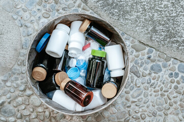 A Dumpster Filled with Discarded Plastic Medicine Containers