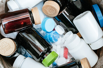 A Dumpster Filled with Discarded Plastic Medicine Containers