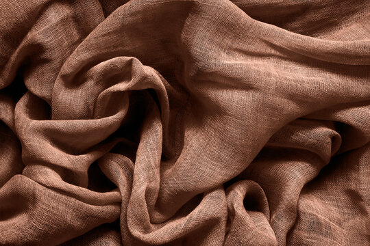 Brown mocha mousse color cotton fabric background. Color of the year 2025.
