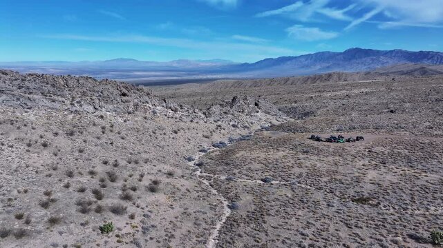 Aerial Bunkerville Nevada desert off road vehicles. Off road trail riding in 4x4 all terrain vehicle for sport and recreation. Nevada Utah Arizona border near Mesquite. Dry arid mountain landscape.