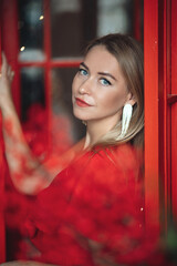 Beautiful elegant woman in red dress with festive makeup,