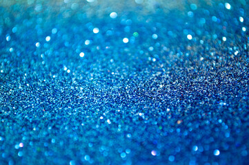 Shimmering blue glitter creates a sparkling surface under bright light