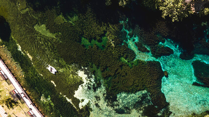 Obraz premium A stunning ancient lake with shades of blue captured by a drone. The vibrant colors create a breathtaking view.