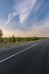 A road with a clear blue sky above it