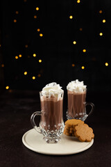 Hot chocolate with creme on dark background, Christmas atmosphere, place for text.