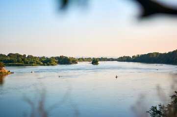 City river at sunset. Relaxation by the river. Resort. Vacation in nature. Weekend on the beach.