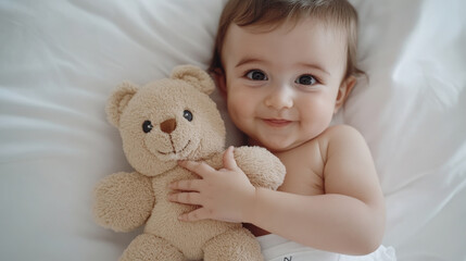 Adorable baby holding plush toy teddy bear in cozy setting