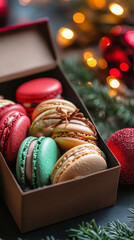 Festive macarons in gift box with holiday lights for christmas celebration
