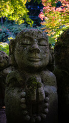 Fototapeta premium Close up of meditating sculpture of buddha in japanese temple garden