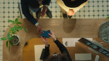 Top view concierge meet guests welcome hotel reception muslim couple tourists travelers arrive...