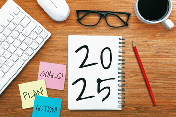2025 Happy New Year Resolution Goal List and Plans Setting - Business office desk with notebook written about plan listing of new year goals and resolutions setting. Change and elation concept.