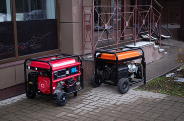 Two portable generators placed outside a building, showcasing power solutions for outdoor and emergency use