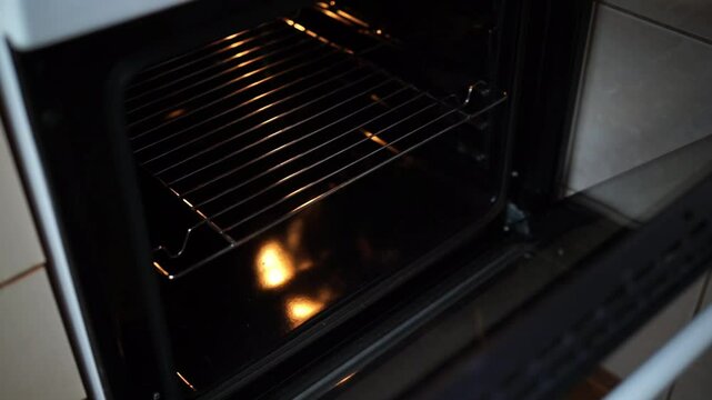 Woman's hands taking out homemade pizza from of oven