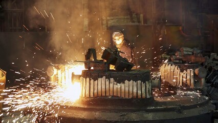 An industrial scene displays vibrant sparks and thick smoke from intricate metalworks. Stock Clip