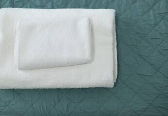 white towels are folded in the hotel on the bed