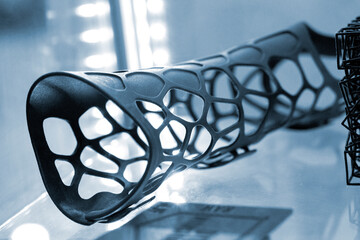 Hand splint corset prosthesis printed on 3D printer from molten black plastic powder. Medical...