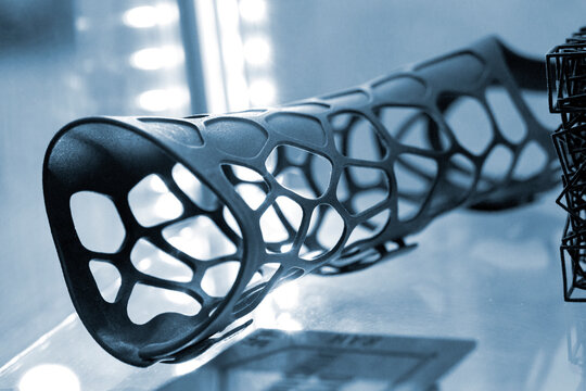 Hand splint corset prosthesis printed on 3D printer from molten black plastic powder. Medical orthosis fixator plastic overlay created on 3D printer. New modern medical 3D printing technologies