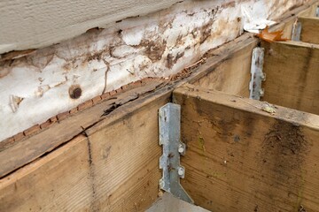 Deck Ledger Board Incorrectly Installed over Wood Siding has led to Extensive Dry Rot and Damage