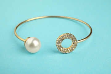 Beautiful bijouterie. Elegant bracelet on light blue background, closeup