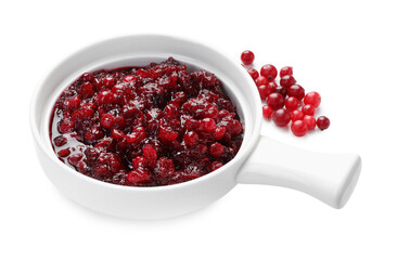 Tasty cranberry sauce in gravy boat and berries isolated on white