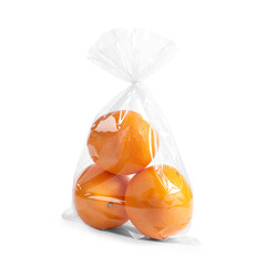 Plastic bag with fresh oranges isolated on white