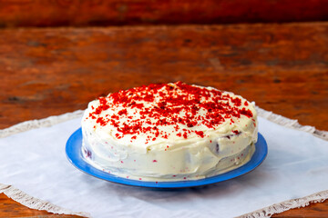Traditional and delicious red velvet cake isolated on blue plate