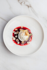 Decadent chocolate lava cake with vanilla ice cream, crunchy meringue, fresh blueberries, and a colorful berry coulis for a luxurious dessert experience. Restaurant or cafe menu, cookbook recipe

