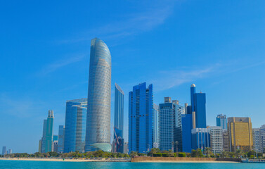 Fototapeta premium Abu Dhabi capital of UAE skyline along Corniche beach taken from a boat