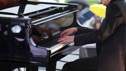 An Elegant Pianist Graces the Stage While Performing at a Lovely Outdoor Event, Captivating All. Clip © Media Whale Stock