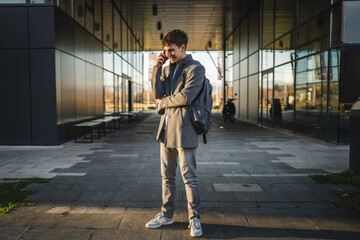 man drink coffee and talk on phone call on cellphone walk outdoor