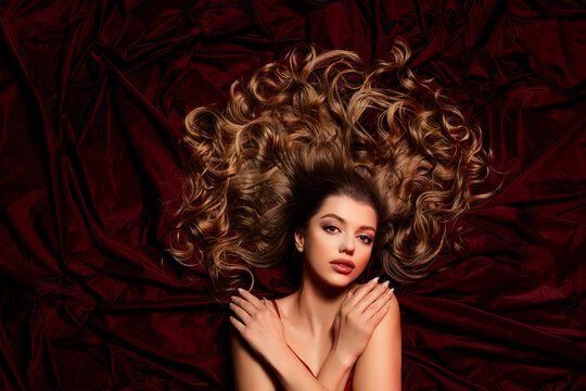 Top view photo of attractive stunning tender lady hug herself isolated on red fabric silky background