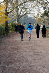 Obraz premium People jogging and walking in Bois de Vincennes park in Paris during a sunny day in autumn