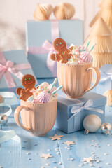 Hot and homemade chocolate as Christmas light blue background.