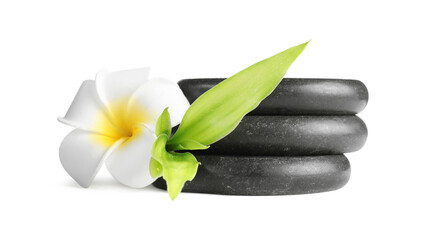 Spa stones, plumeria flower and green leaves isolated on white