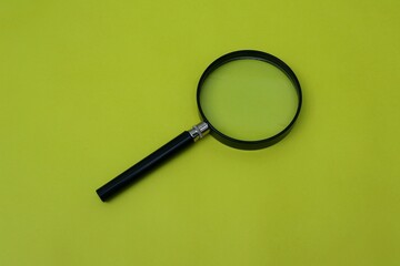 Magnifying glass on yellow background