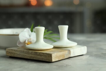 Spa stones and orchid flower on grey table, closeup