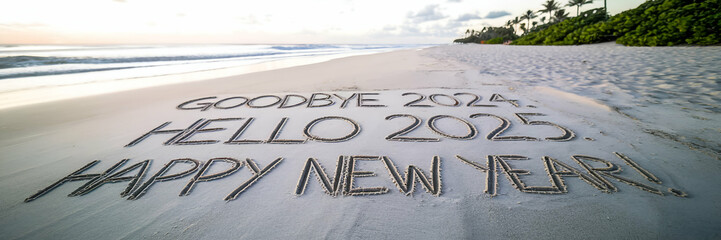 Goodbye 2024. Hello 2025. Happy New Year written on the sand at the seashore. The waves are gently lapping at the shore, and the sand is smooth and wet. The background contains a few rocks.