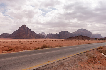 A road in the desert with mountains in the background