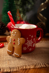 Gingerbread man cookies and hot chocolate with marshmallow, traditionally made at Christmas and the holidays.