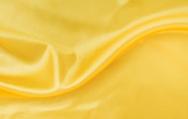Fototapeta premium yellow gold satin texture that is white silver fabric luxurious shiny that is abstract silk cloth background with patterns soft waves blur beautiful.