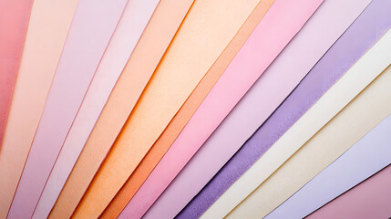 Fototapeta premium A vibrant array of pastel-colored paper sheets arranged in a radial pattern, showcasing a gradient of soft hues from peach to lavender. Perfect for design, texture, or color palette inspiration.