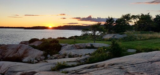 Sunset on the horizon as seen from Coolidge reservation in Manchester by the sea in Massachusetts, USA