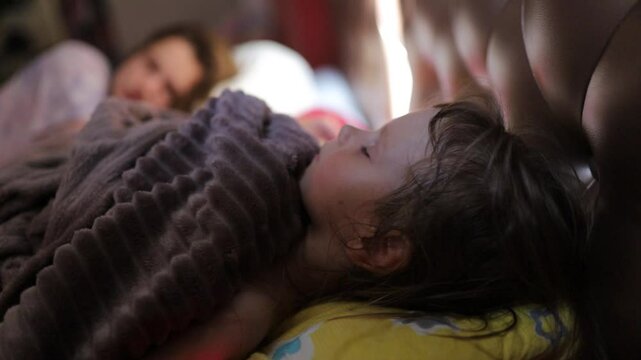 a little girl sleeps in bed during the day